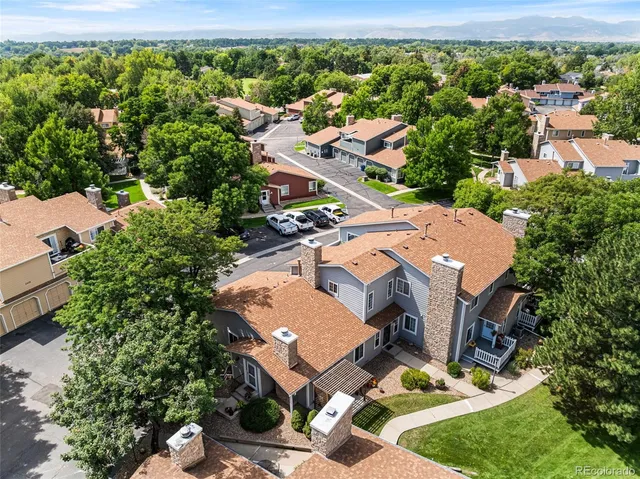 an aerial view of a house with a yard