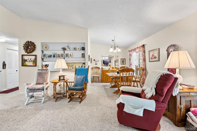 a living room with furniture and a lamp