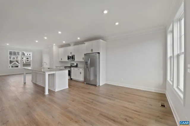 a view of kitchen with stove and cabinets