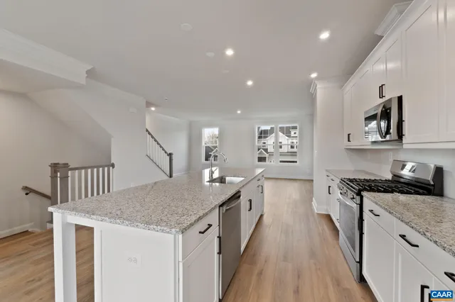 a kitchen with granite countertop a stove and a sink