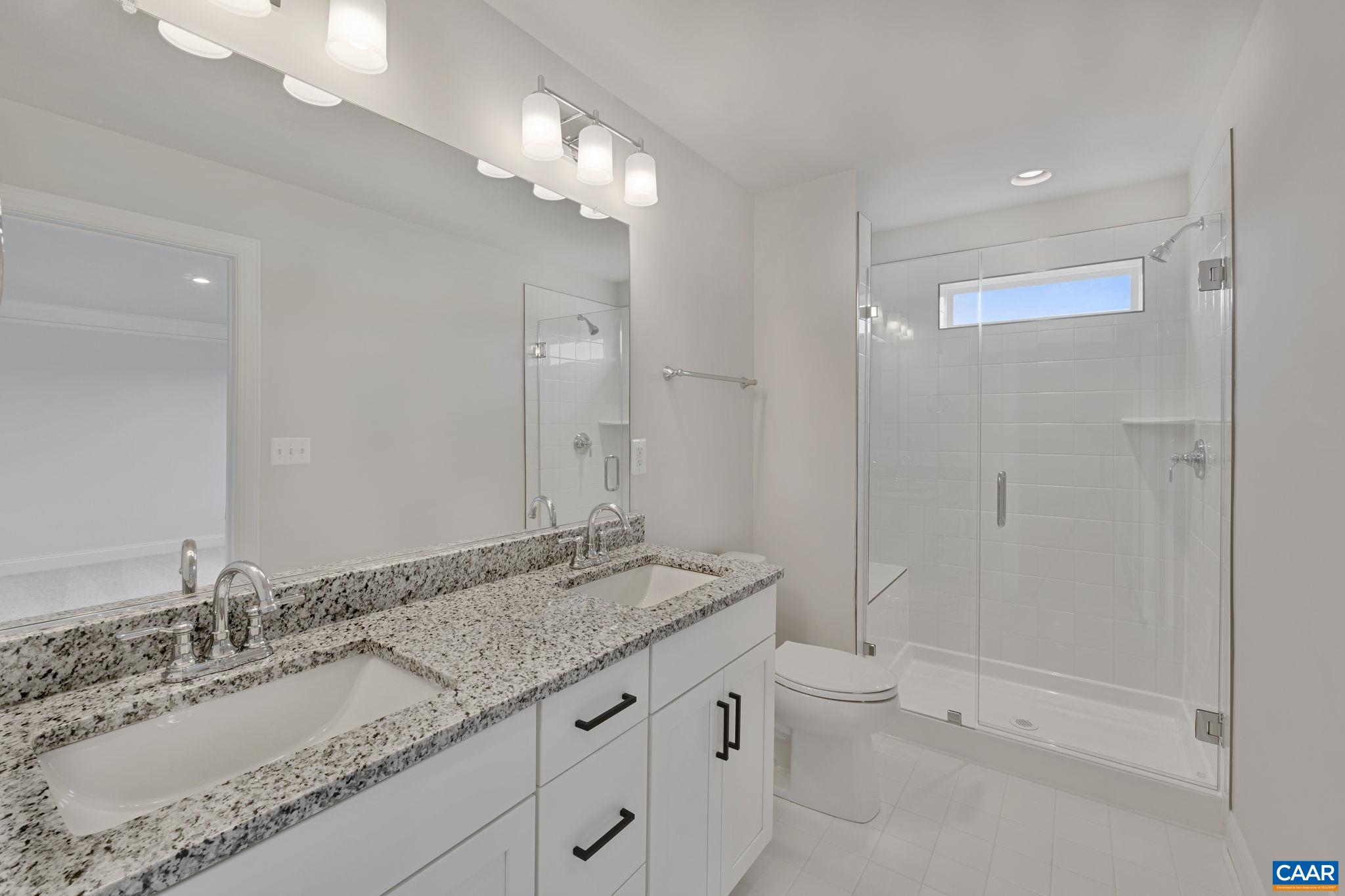 33 Talen Lane Charlottesville, VA 22911 - Photo 29 of 44 a bathroom with a granite countertop sink a toilet and shower