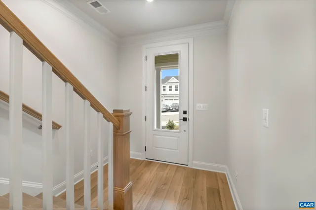 a view of entryway with wooden floor and stairs