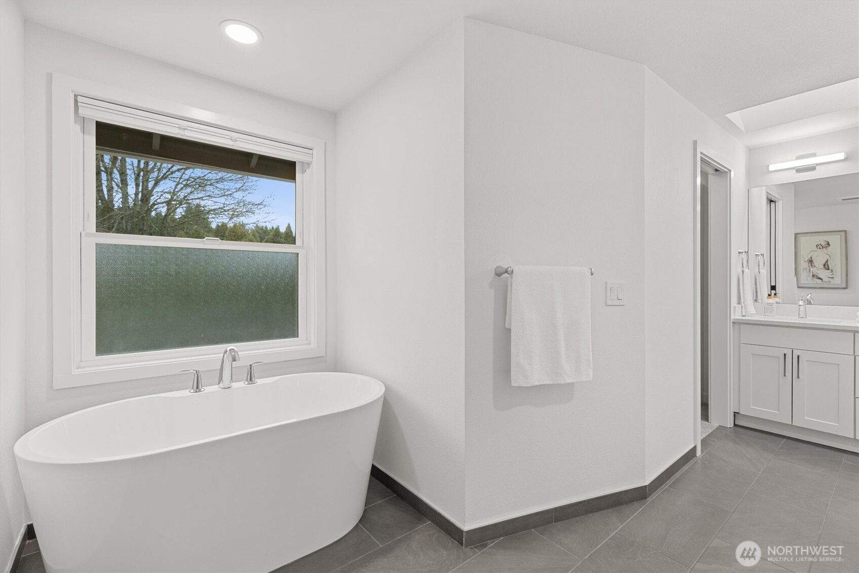 16302 123rd Place Northeast Bothell, WA 98011 - Photo 22 of 37 a white tub sitting next to a bathroom