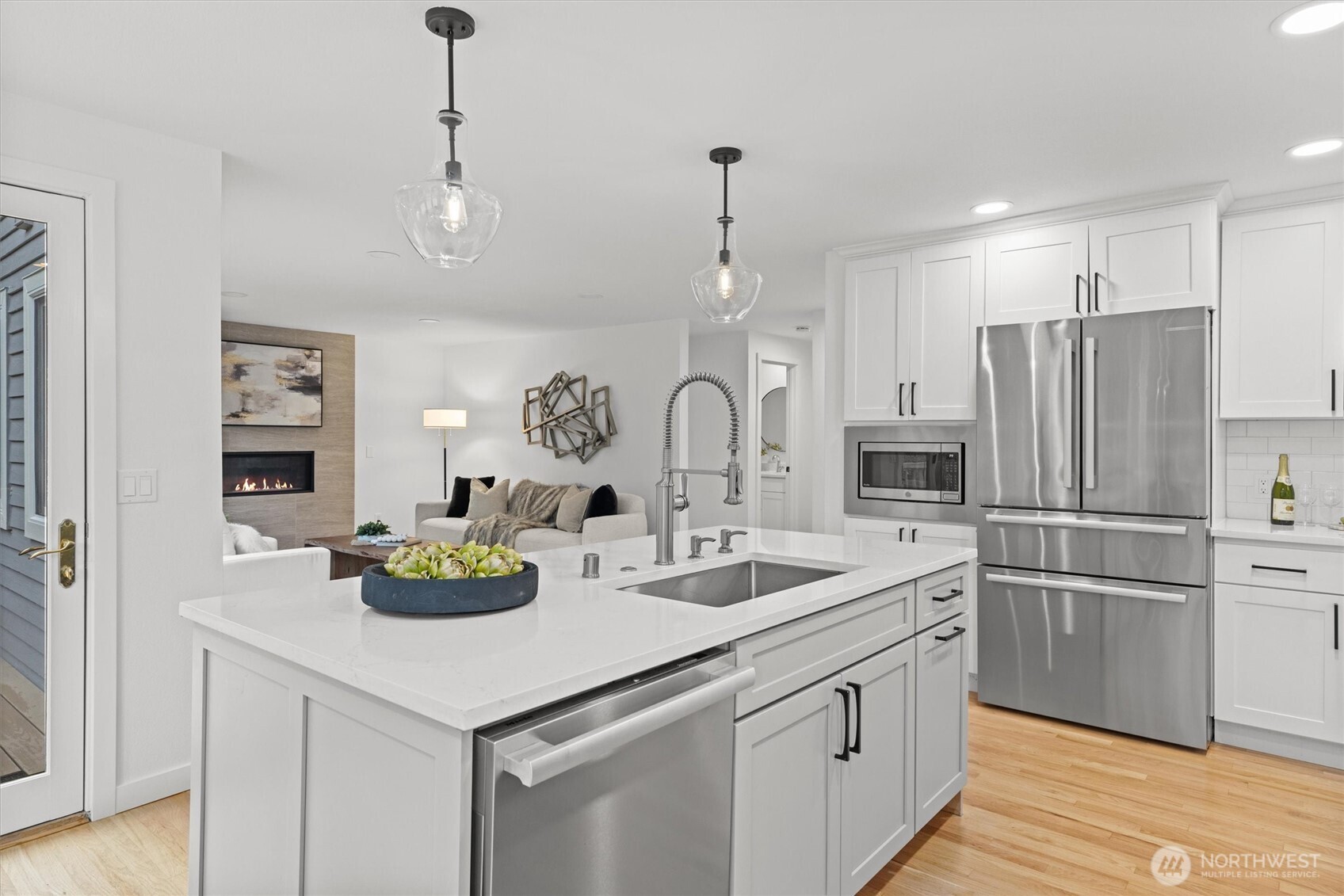 16302 123rd Place Northeast Bothell, WA 98011 - Photo 9 of 37 a kitchen with stainless steel appliances a sink a stove a refrigerator and white cabinets with wooden floor