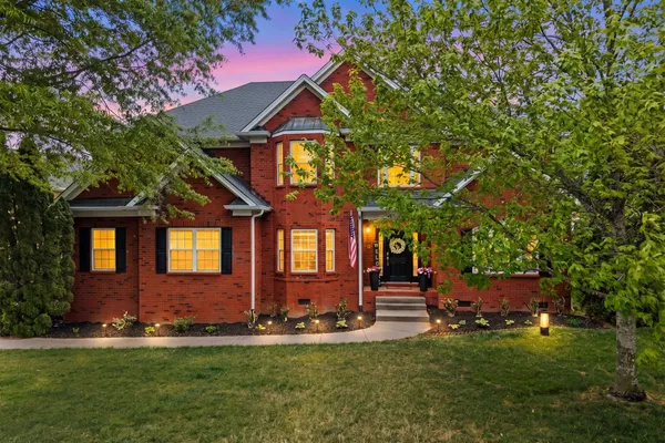 a front view of a house with a yard