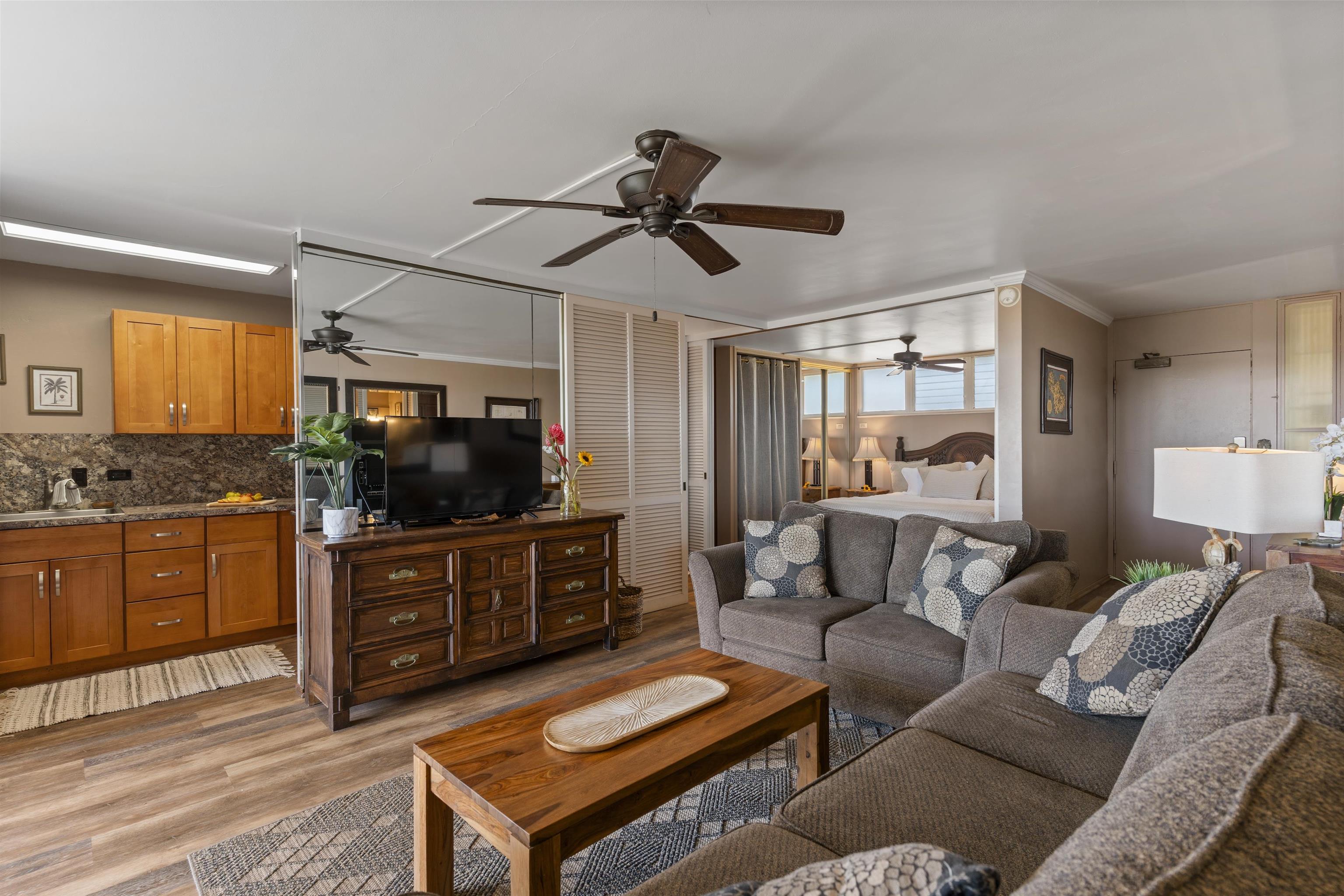 3823 Lower Honoapiilani Road, Unit 401 Lahaina, HI 96761 - Photo 13 of 40 a living room with furniture a ceiling fan and a rug