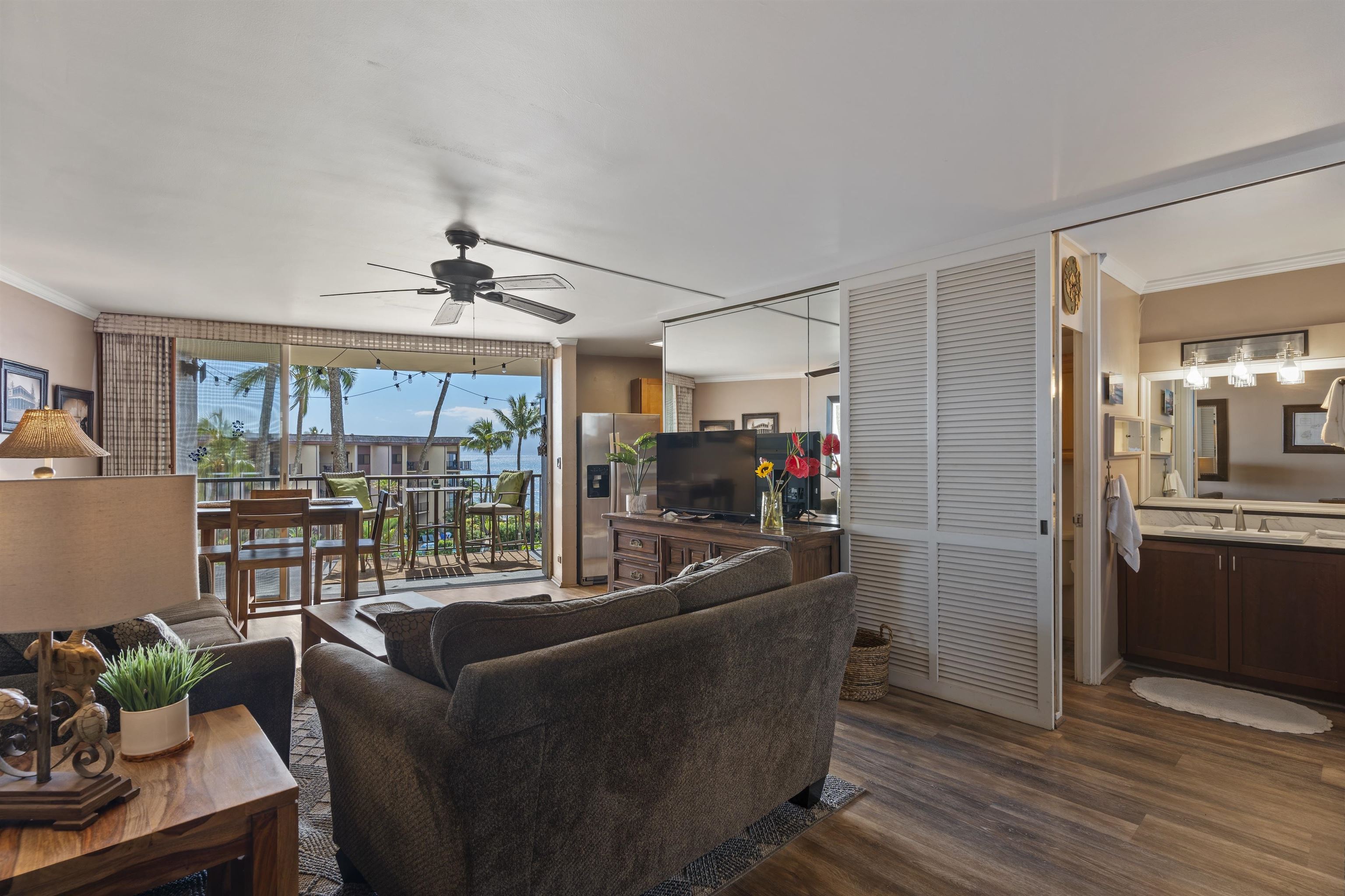 3823 Lower Honoapiilani Road, Unit 401 Lahaina, HI 96761 - Photo 15 of 40 a living room with furniture and a floor to ceiling window