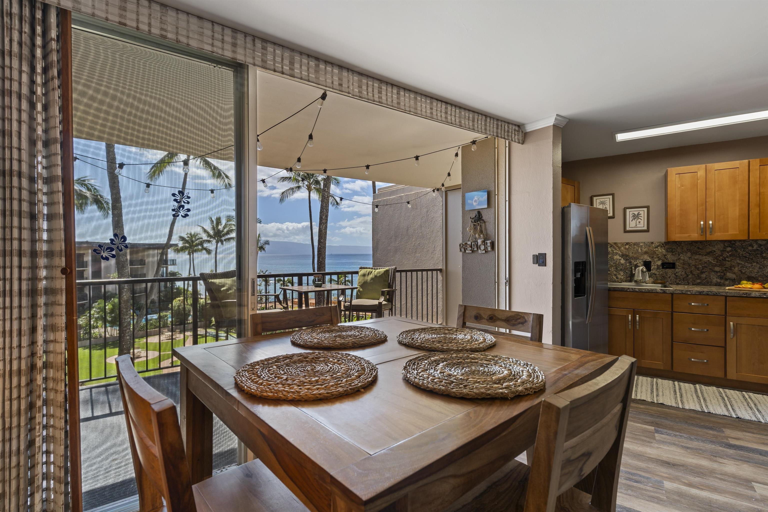 3823 Lower Honoapiilani Road, Unit 401 Lahaina, HI 96761 - Photo 21 of 40 a view of a dining room with furniture window and wooden floor
