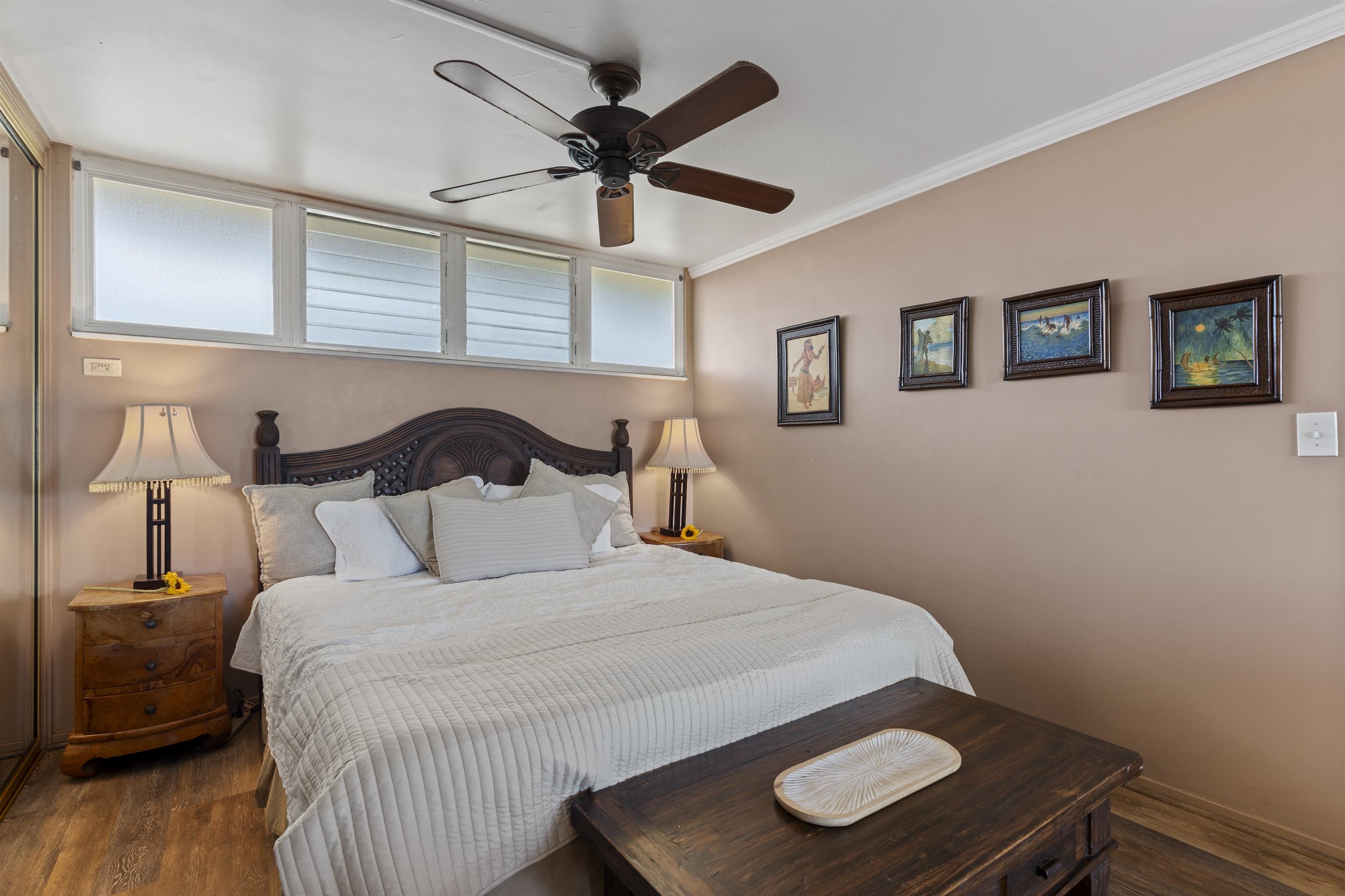 3823 Lower Honoapiilani Road, Unit 401 Lahaina, HI 96761 - Photo 29 of 40 a bedroom with a bed and wooden floor