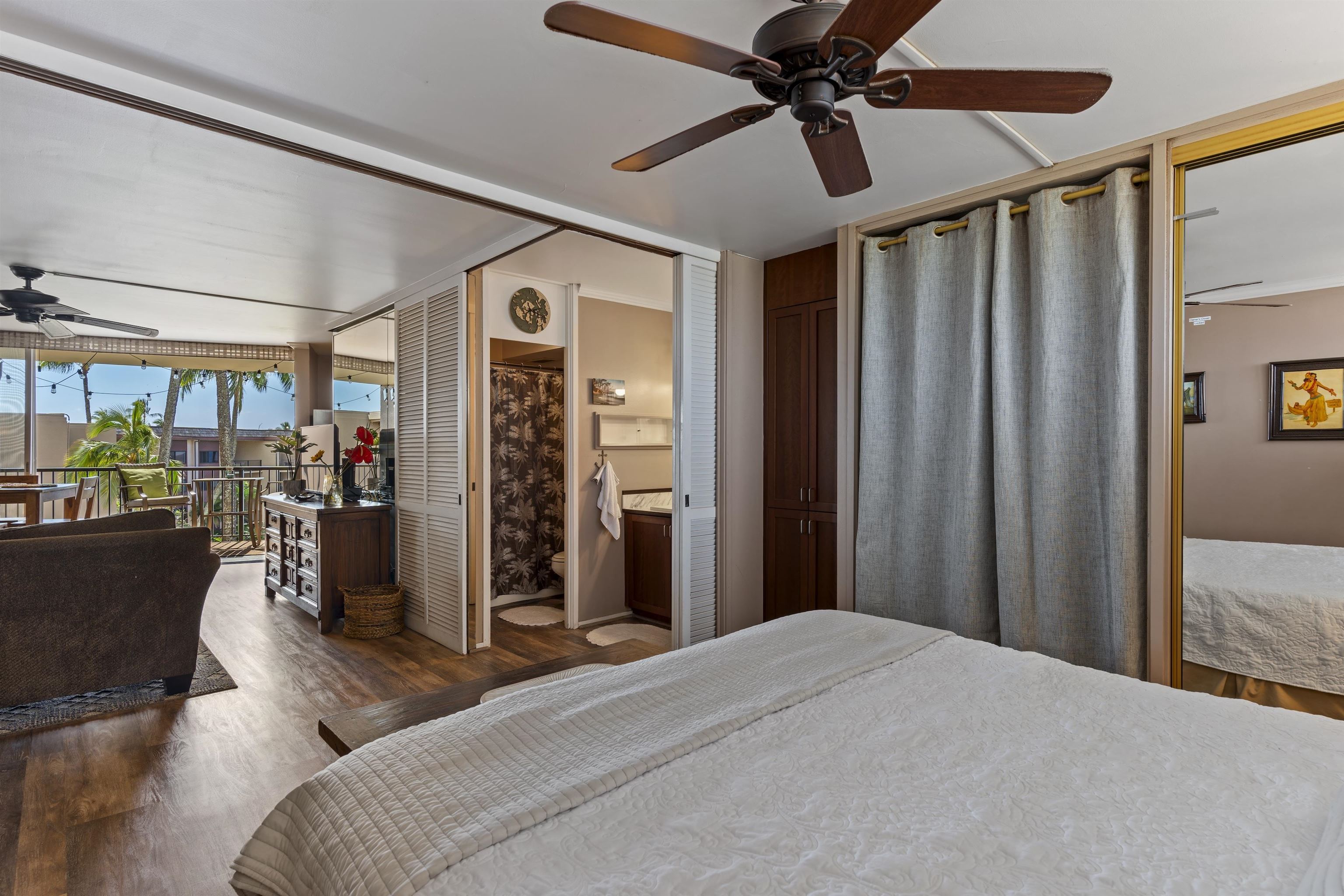 3823 Lower Honoapiilani Road, Unit 401 Lahaina, HI 96761 - Photo 31 of 40 a bedroom with bed and a chandelier