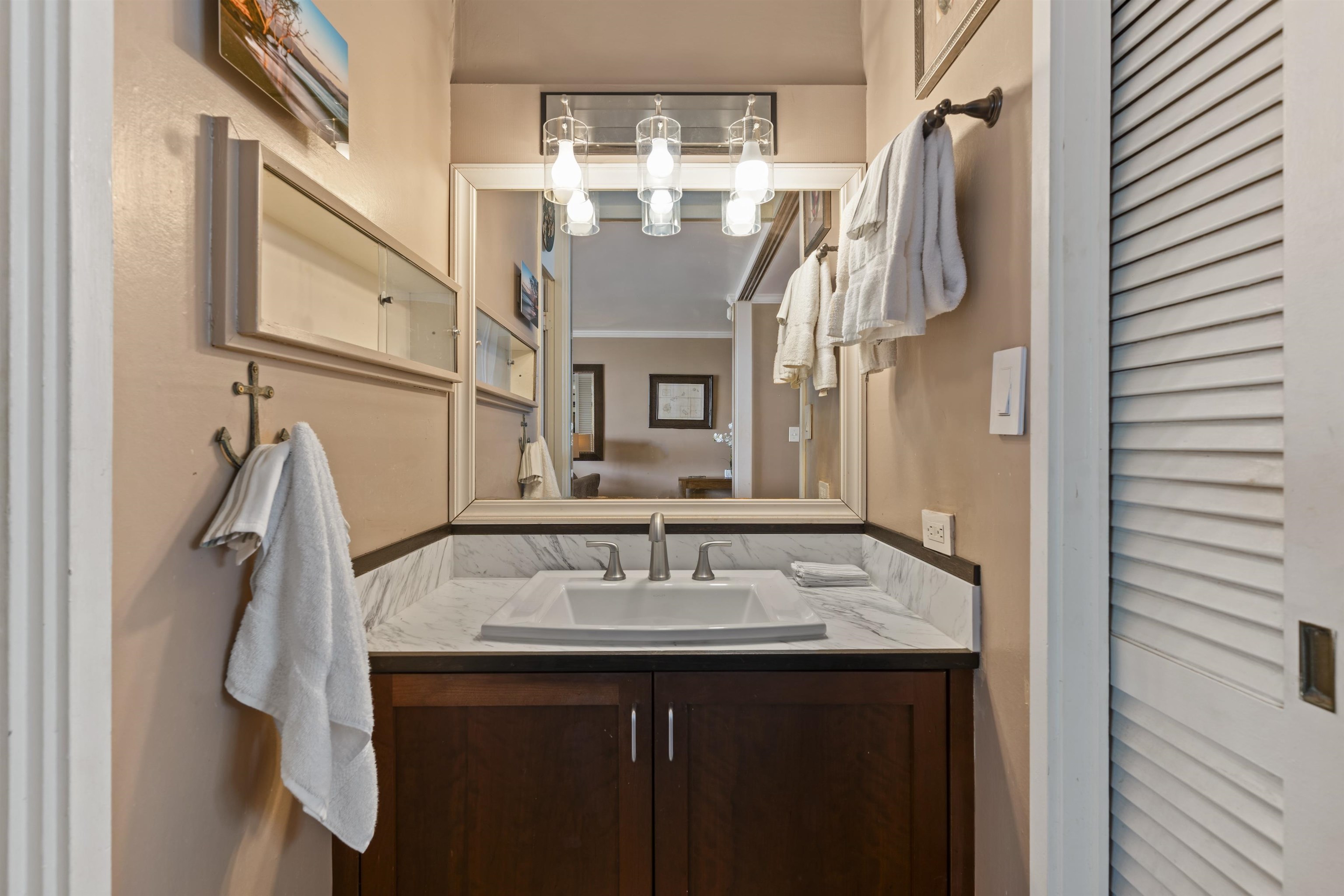 3823 Lower Honoapiilani Road, Unit 401 Lahaina, HI 96761 - Photo 32 of 40 a bathroom with a sink vanity and a mirror
