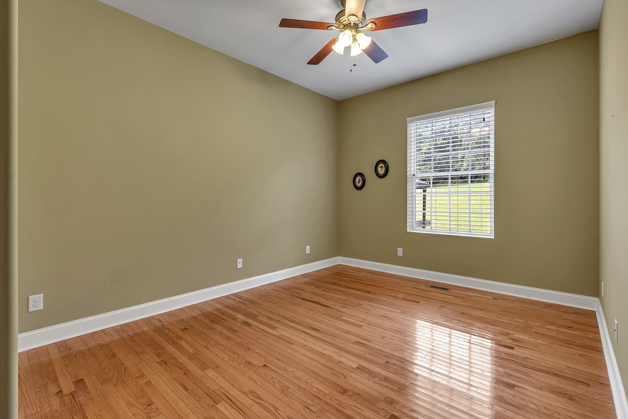 790 Blooming Grove Road Pulaski, TN 38478 - Photo 41 of 74 a view of an empty room with wooden floor and a window