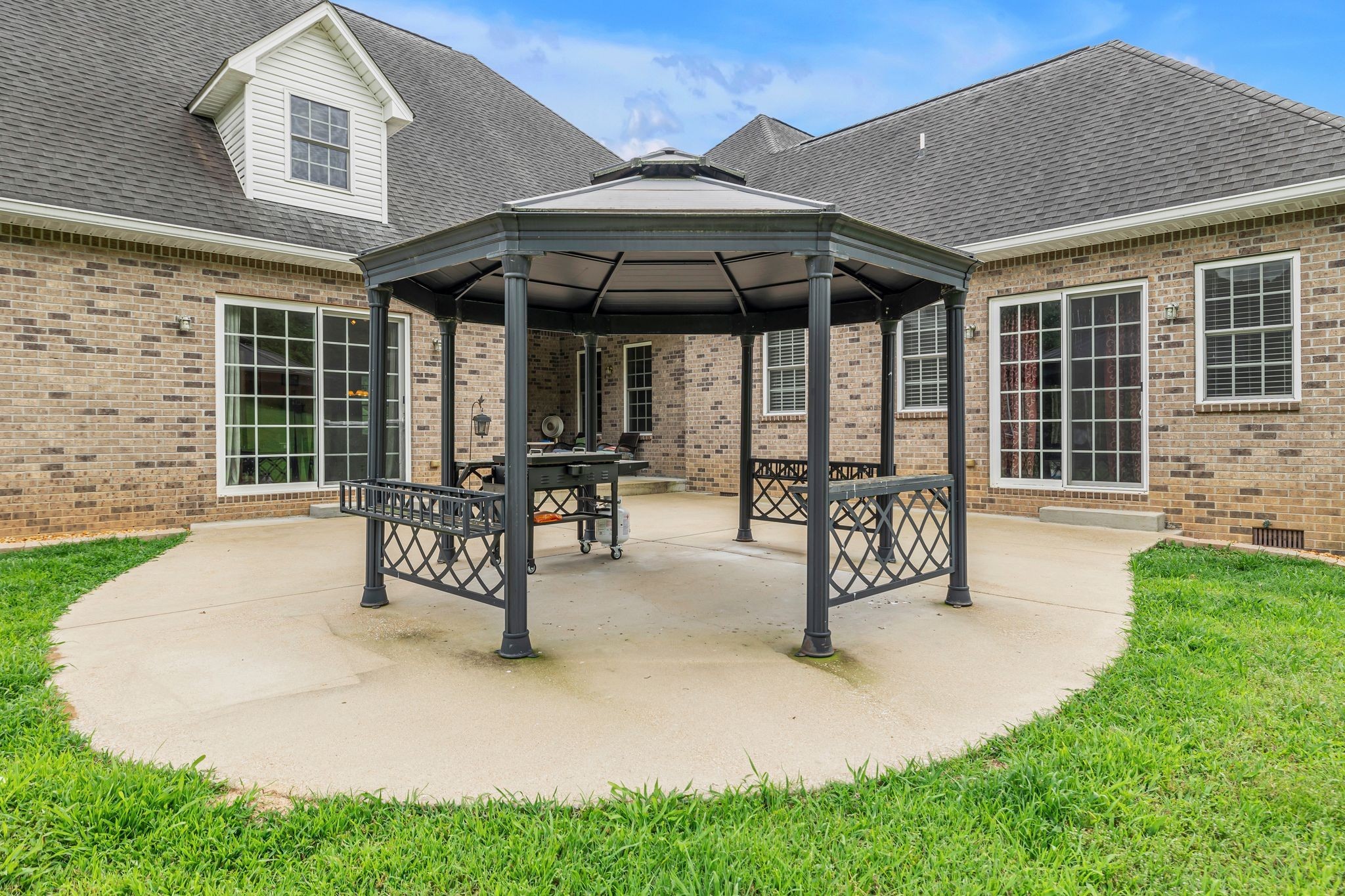 790 Blooming Grove Road Pulaski, TN 38478 - Photo 54 of 67 a view of a patio with table and chairs under an umbrella