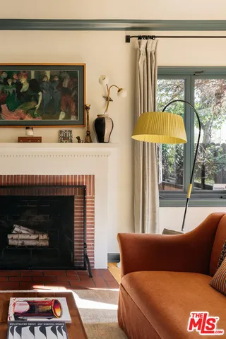 a living room with a couch a fireplace and a flat screen tv