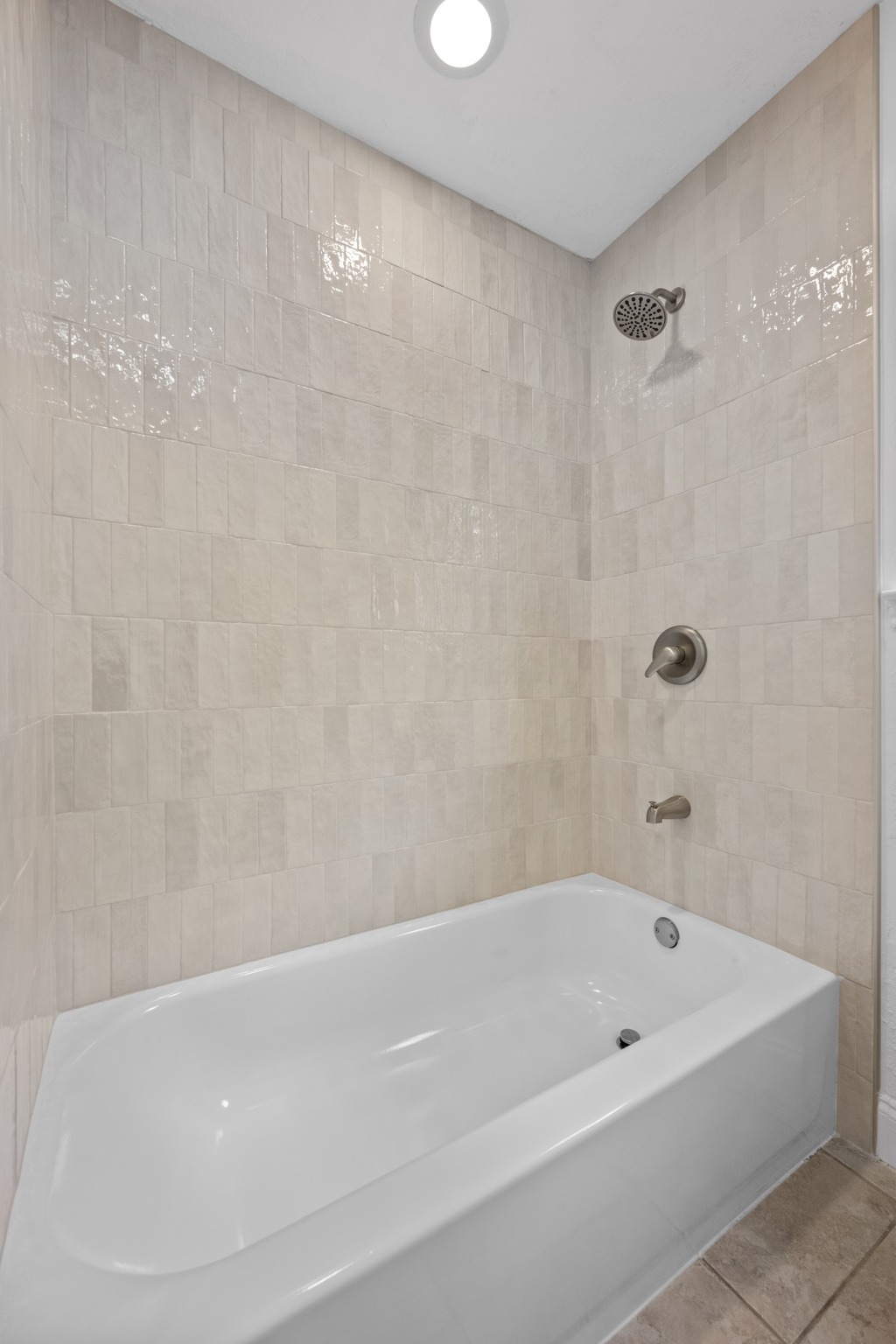 7210 Smokey Hill Road Austin, TX 78736 - Photo 22 of 29 A well-appointed bathroom features a bathtub with shower and tiled surround.