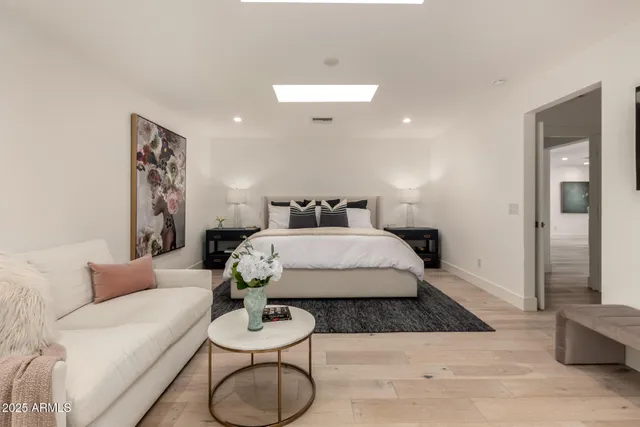a bedroom with a bed and glass wall