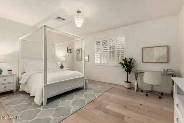 a bedroom with a bed and a table in it