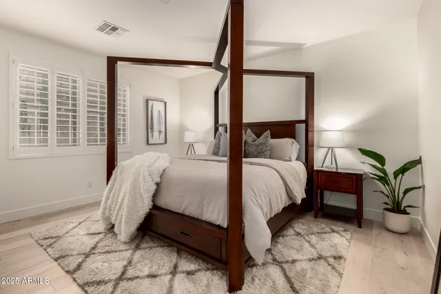 a bed room with a bed and a mirror