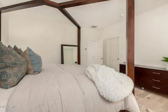 a bedroom with a bed and a dresser