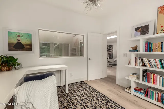 a bedroom with furniture and a book shelf