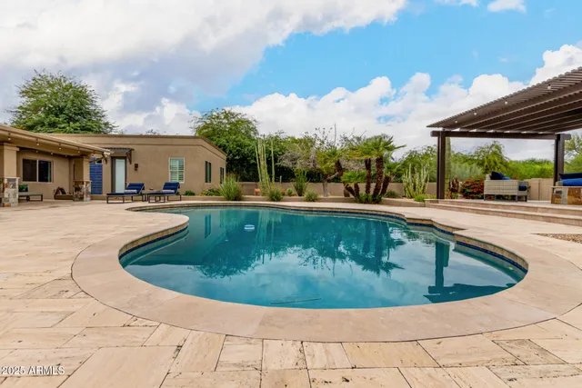 a view of swimming pool with outdoor seating