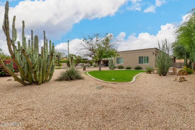 a view of a house with a backyard and a garden