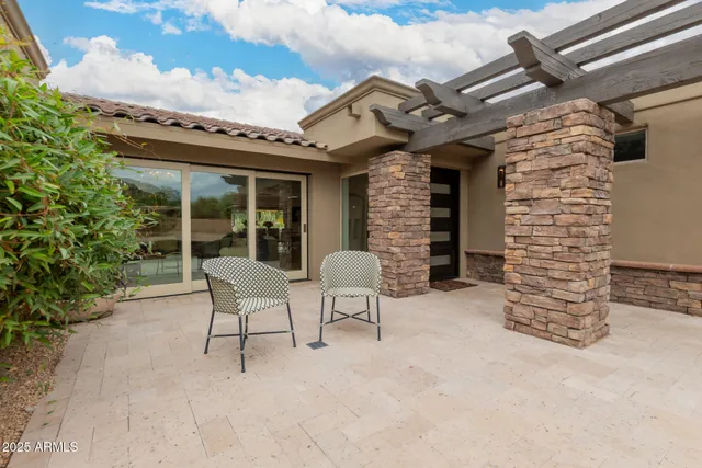 a view of a patio with a table and chairs and potted plants