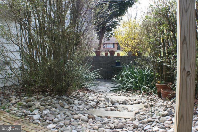 7900 Clearfield Road Frederick, MD 21702 - Photo 14 of 30 River stone path from the yard to the courtyard