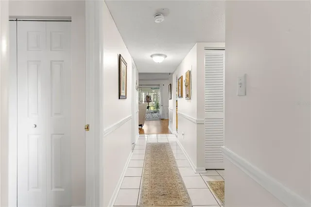 a white kitchen with a sink and refrigerator