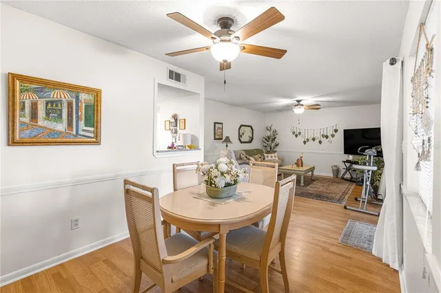 a view of a hallway with wooden floor and furniture