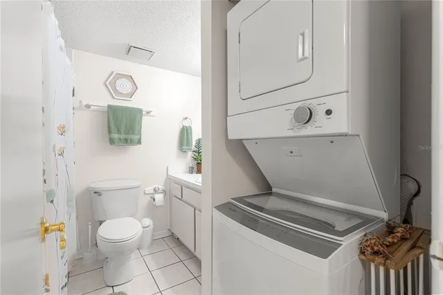 a view of a livingroom with furniture and floor to ceiling window
