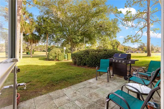 a view of a building with sitting area and garden