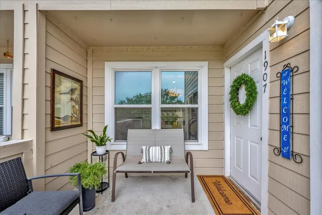 a front view of a house with outdoor seating and a potted plant