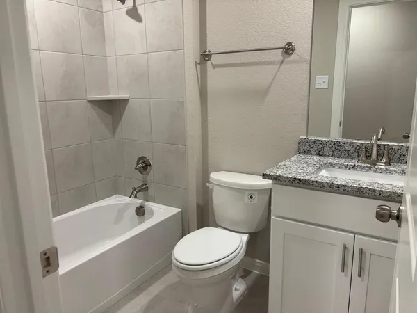 a view of wooden floor and chandelier fan in a room