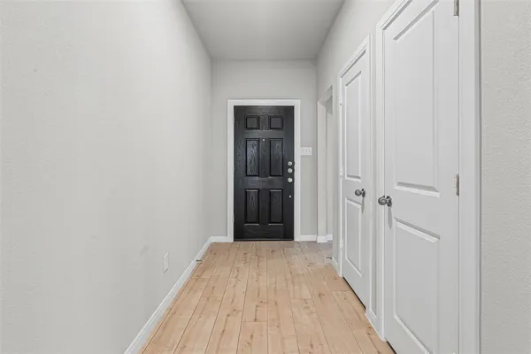 a view of a hallway with wooden floor