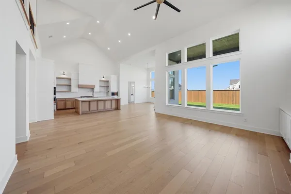 a view of kitchen and hall with wooden floor
