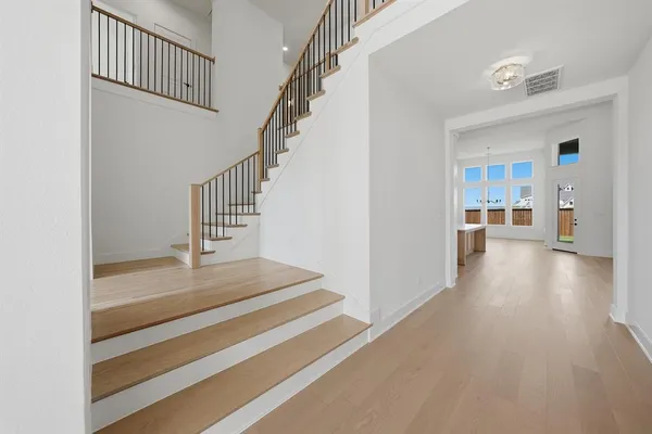 a view of entryway and hall with wooden floor