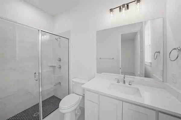 a bathroom with a sink toilet and shower