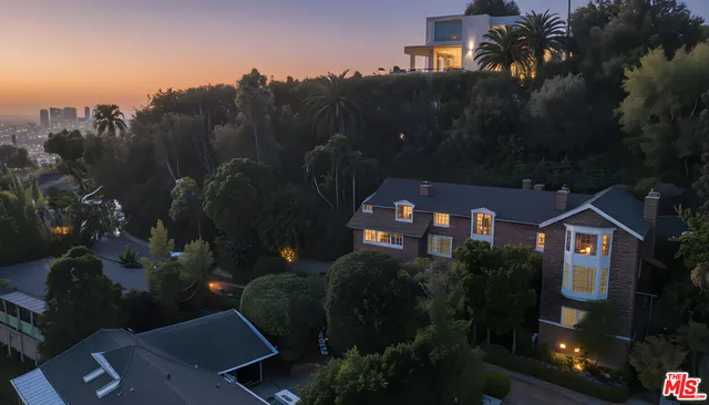 a aerial view of a house with swimming pool and sitting area