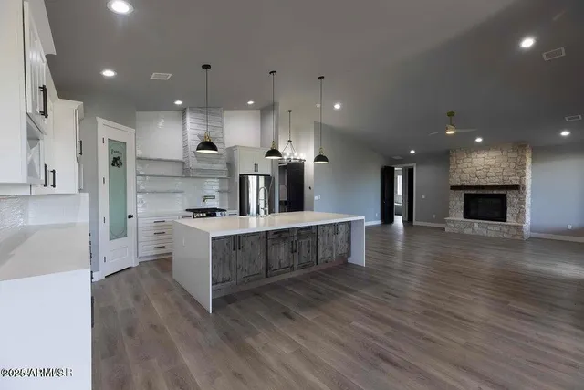 a large white kitchen with lots of counter space a sink and appliances