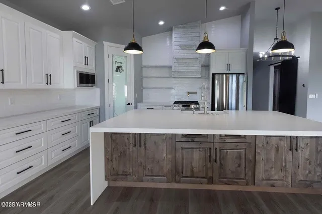 a kitchen with a sink stainless steel appliances and cabinets