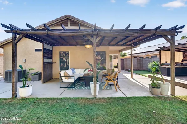 a view of a chairs and table in a backyard