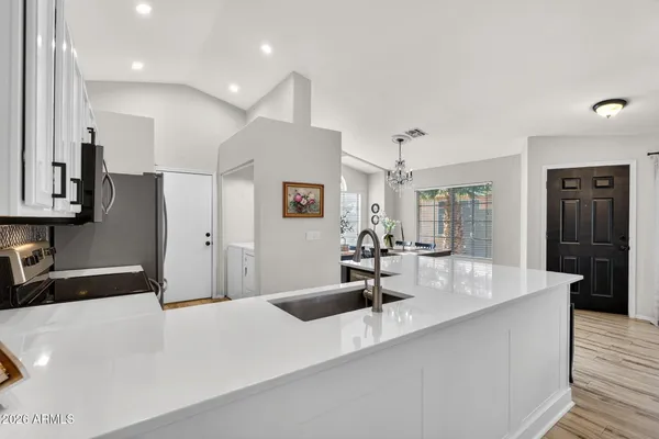 a kitchen with a sink stove and microwave
