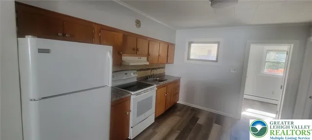 a kitchen with a refrigerator sink and stove