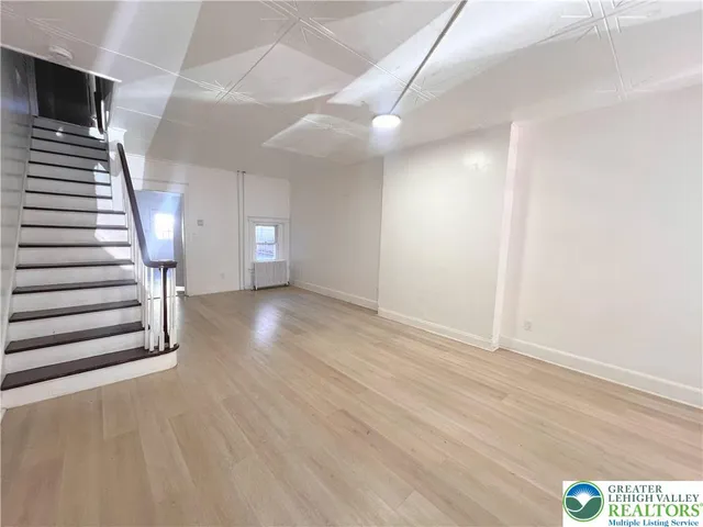 a view of an empty room with stairs and stairs