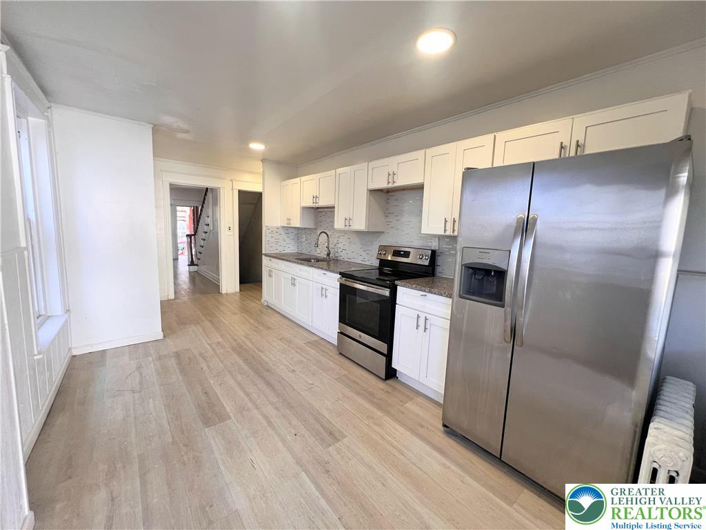 215 South Franklin Street Allentown, PA 18102 - Photo 5 of 13 a kitchen with stainless steel appliances a refrigerator and a stove top oven