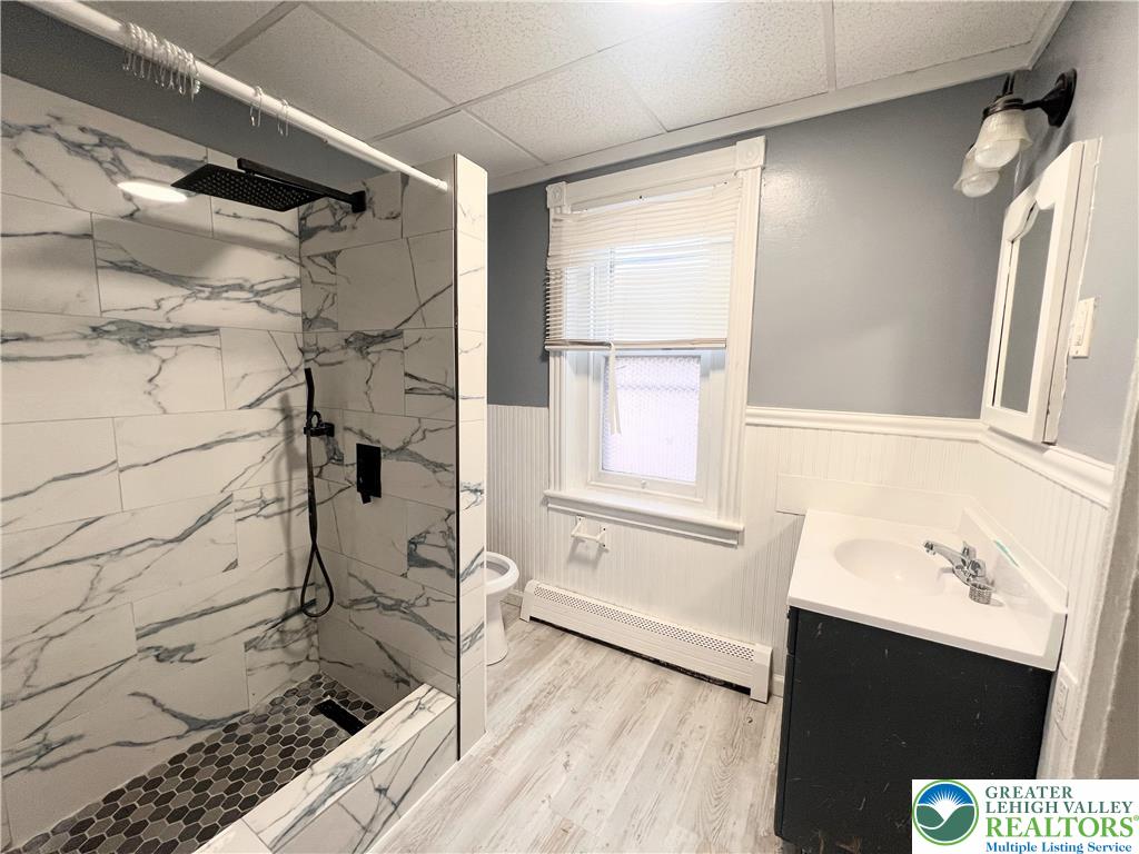 215 South Franklin Street Allentown, PA 18102 - Photo 6 of 13 a bathroom with a granite countertop sink toilet and shower