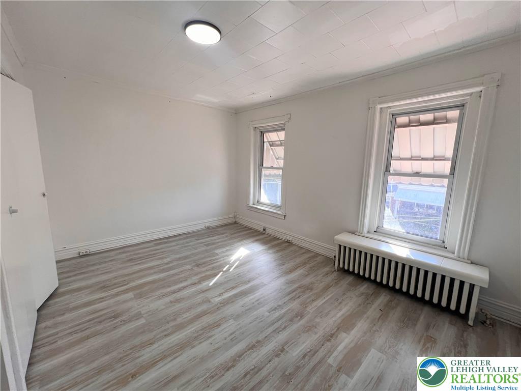 215 South Franklin Street Allentown, PA 18102 - Photo 7 of 13 an empty room with wooden floor and windows
