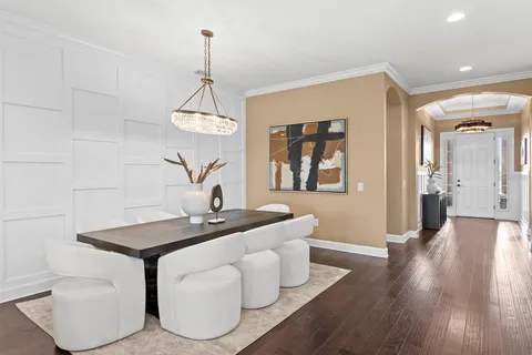 a living room with furniture and a chandelier