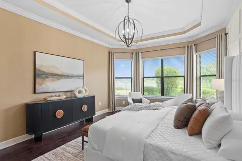 a bedroom with furniture and a large window